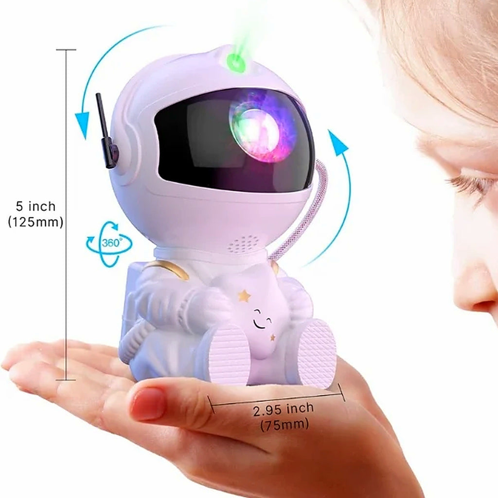 Mini astronaut galaxy projector held in hand showing compact size