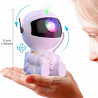 Mini astronaut galaxy projector held in hand showing compact size