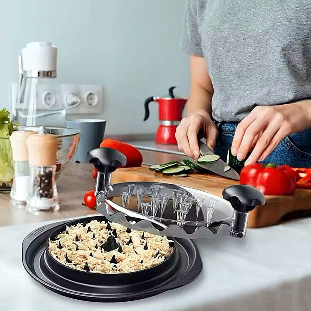 Manual chicken shredder in use on a kitchen counter