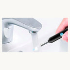 Rinsing the ear cleaner tip under tap