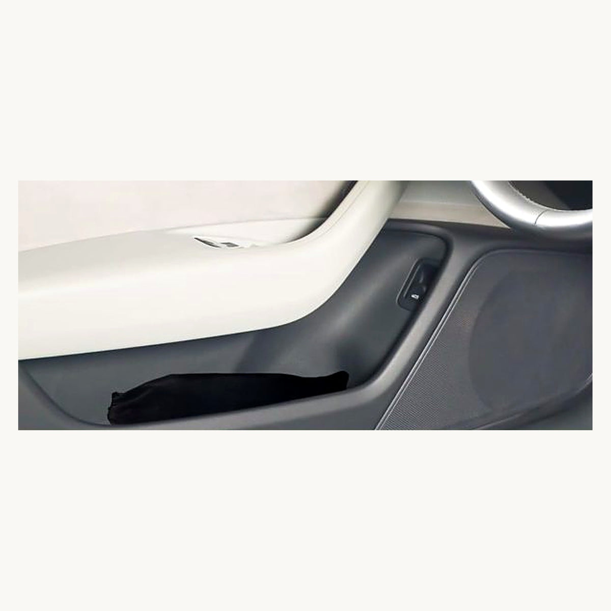 Folded sunshade stored in car door pocket